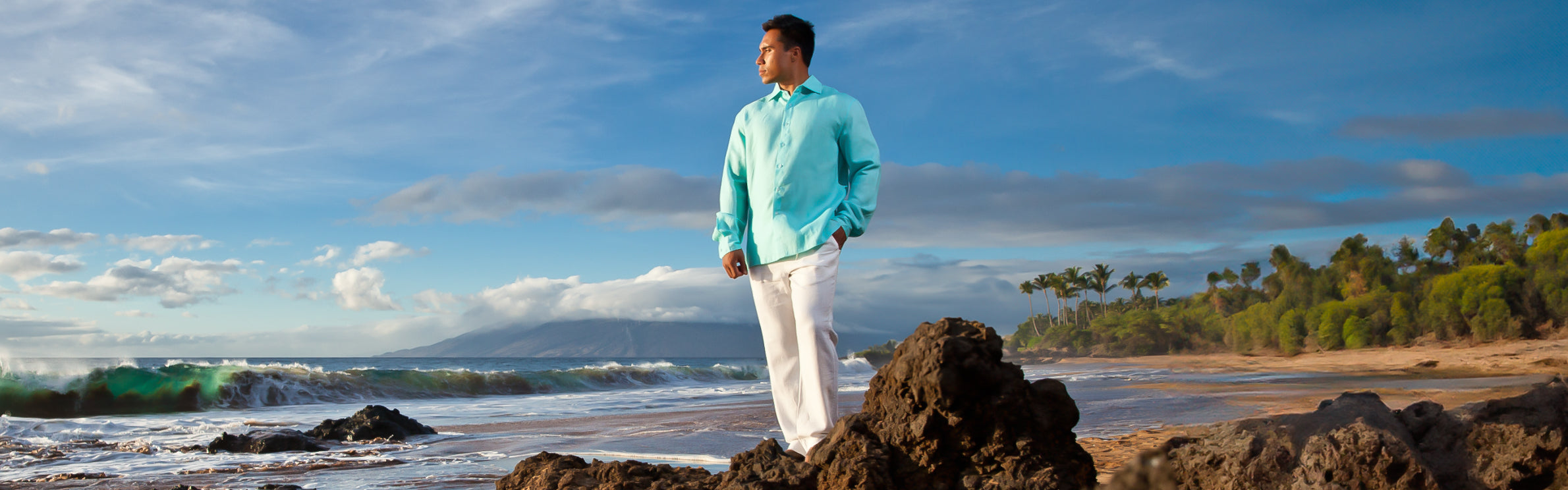 Island Importer linen clothing styled on a tropical shoreline